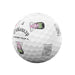 A white Callaway Chrome Tour golf ball with black text and cartoon character graphics, isolated on a white background.