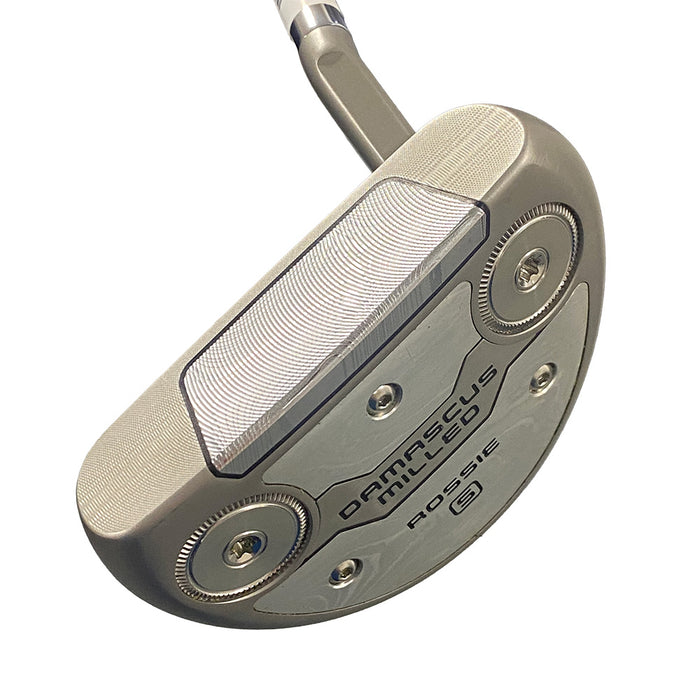 A close-up studio shot of a golf putter head on a white background, showing the model 'Damascus Milled Rossie S'.