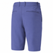 A pair of men's golf shorts in a muted periwinkle crystal blue color, shown from the back. The shorts feature belt loops, a button closure, two welt back pockets, and a small tonal embroidered logo on the upper right side.