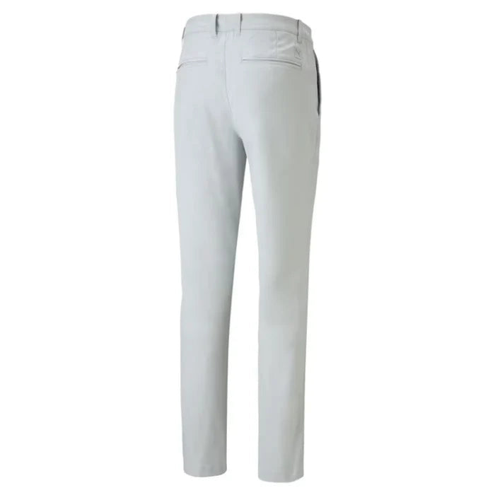 A pair of light gray slim-fit trousers shown from the back, featuring a belt loop, two rear patch pockets, and a button closure, displayed on a solid white background.