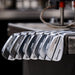 A set of Taylormade RORS•PROTO Irons with a silver finish, displayed in a row with the brand and model name visible.