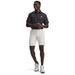 zoomed out View of the Under armour tapered drive shorts being worn by a model as seen from the front